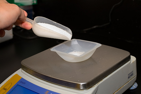 weighing white powder with scoop