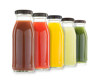 Drinks, such as fruit and vegetable-based beverages, are safe in glass bottles due to their non-toxic material.